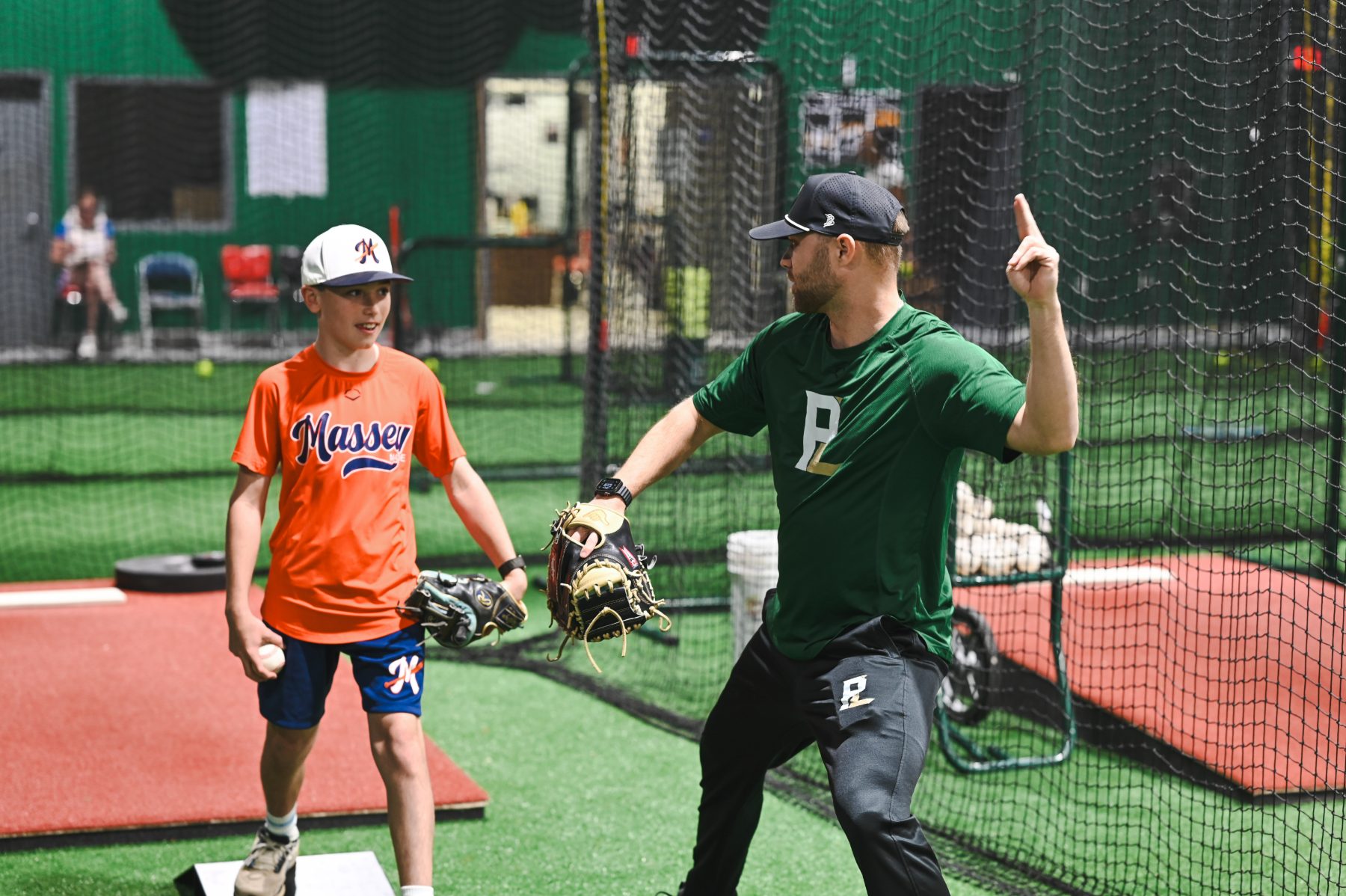 Coach Cody Stull instructing a young pitcher during a session at The Pitch Lab