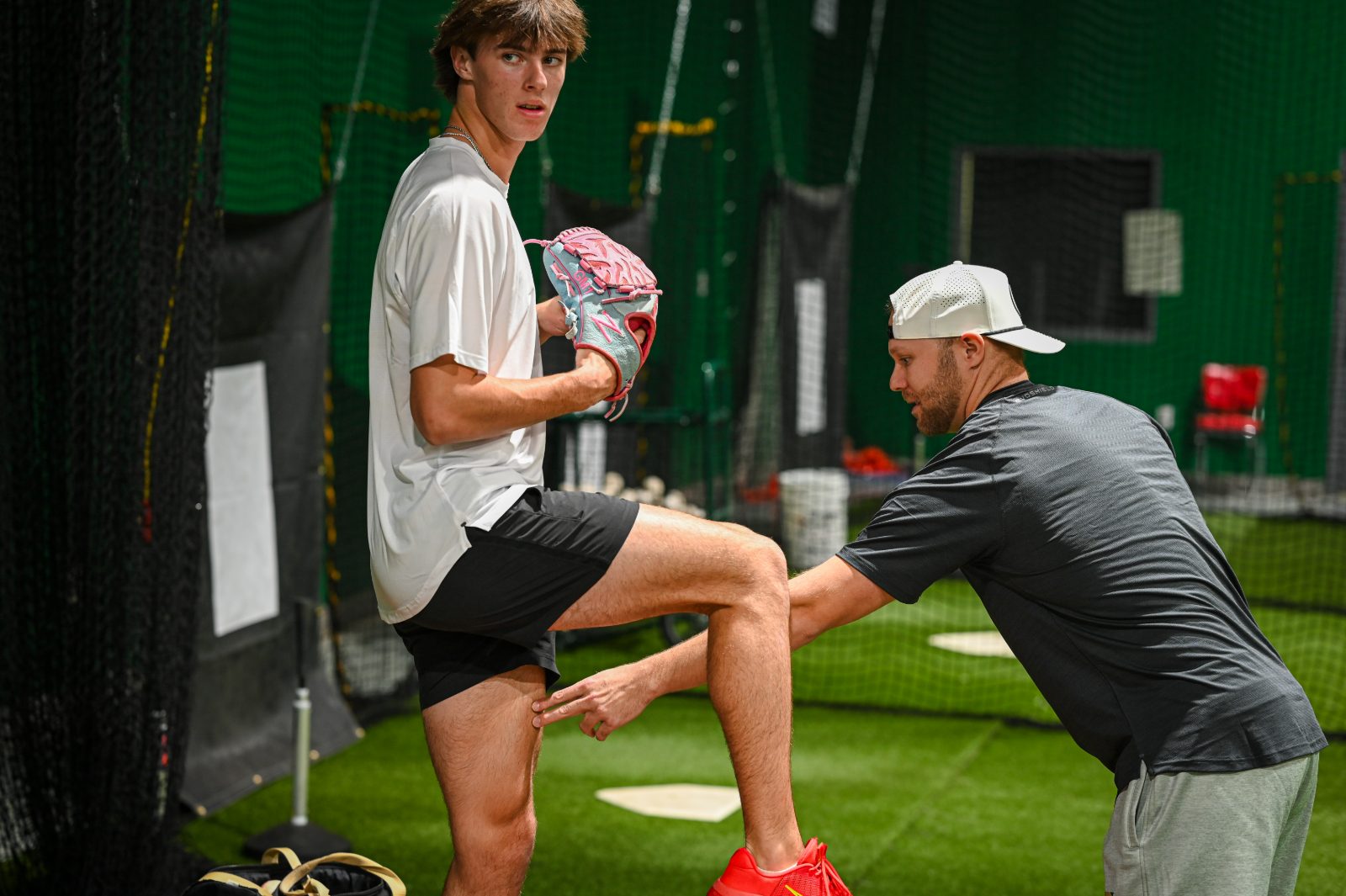Coach Cody Stull coaching an athlete through balance and leg-lift mechanics at The Pitch Lab